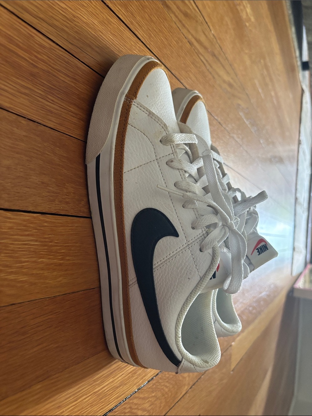 Nike White Sneakers with Black Swoosh and Amber Accent